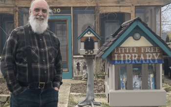 Little Free Library steward Lou Host-Jablonski with his personalized book box. Photo by Alyssa Lutker.